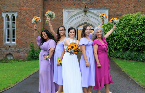 Brides celebrating with her Bridesmaids Hertford Castle in the background